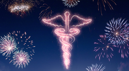 A dark night sky with a sparkling red firecracker in the shape of an asclepius symbol composed into.(series)の写真素材