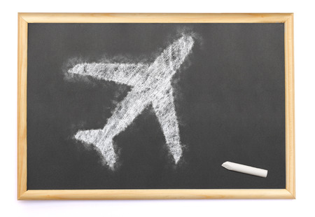 Blackboard with an airplane drawn on and a single chalk.(series)の写真素材