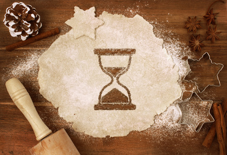 Festive cookie dough with the shape of an hourglass cut out (series)の写真素材