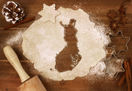 Festive cookie dough with the shape of Finland cut out (series)の写真素材
