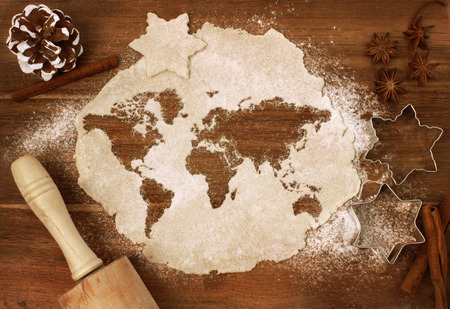 Festive cookie dough with the shape of the world cut out (series)の写真素材