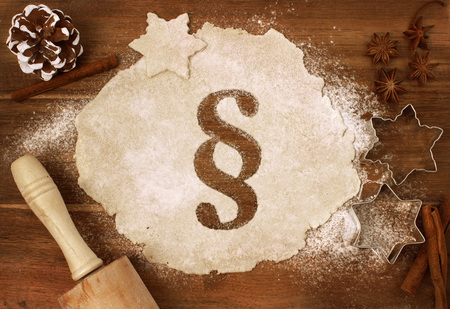 Festive cookie dough with the shape of a paragraph symbol cut out (series)の写真素材