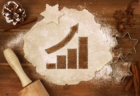 Festive cookie dough with the shape of a growing bar chart cut out (series)の写真素材