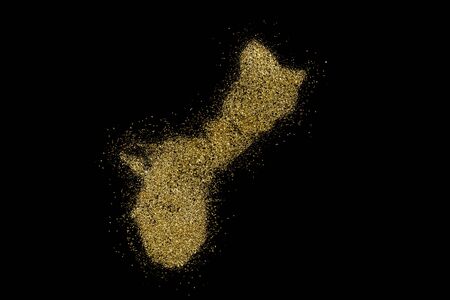 Guam shaped from golden glitter on a black background (series)の写真素材