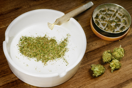 Crumbled weed in the shape of USA and a joint.の写真素材