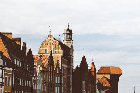 Polish tourist attractions and europe tourism concept. Beautiful old city roofs, church, Gdansk old town.の写真素材