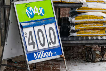 An OLG sign outide of a grocery store in Ottawa boasts a 40-million-dollar Lotto Max national lottery jackpot for a Friday Drawing on a snowy winter day.のeditorial素材