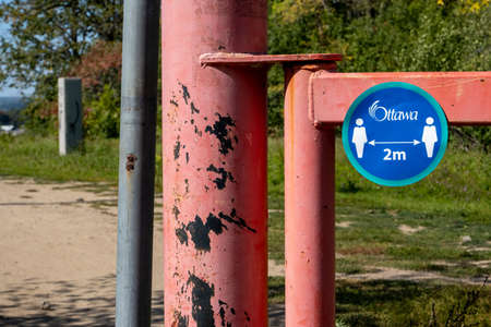 A City of Ottawa decal in Carlington Park reminds visitors to maintain a physical distance of 2 meters from others during the COVID-19 pandemic.のeditorial素材