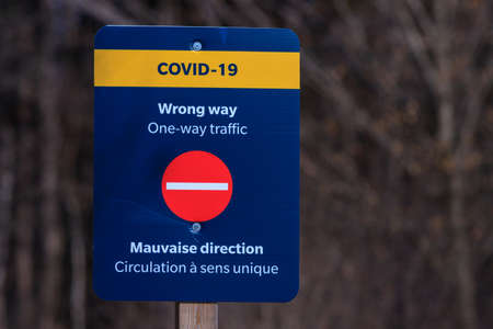 Ottawa, Ontario, Canada - March 17, 2021: A National Capital Commission (NCC) wrong-way sign at the Mer Bleue Bog Boardwalk informs visitors that the trail is one-way during the COVID-19 pandemic.のeditorial素材