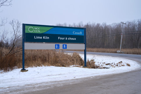 Ottawa, Ontario, Canada - January 1, 2022: A National Capital Commission (NCC) sign for Lime Kiln Trail in the Stoney Swamp conservation area on Moodie Drive.のeditorial素材