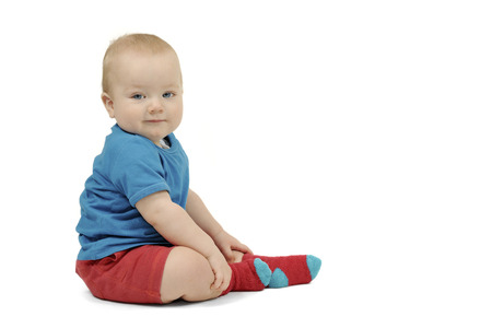 Little boy sitting on white background, isolated