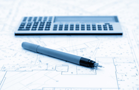 Architectural plans, calculator and drawing utensil. Picture in blue tone.の写真素材