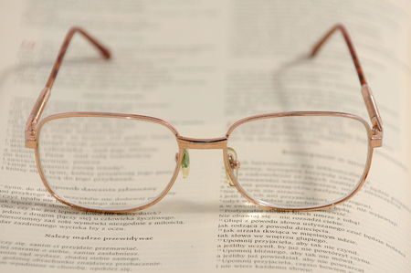 Eyeglasses lying on an old book (the New Testament)の写真素材