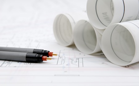 Rolled-up architectural plans and drawing utensilsの写真素材
