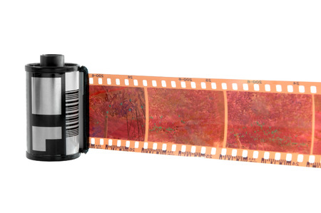 Old photographic 35 mm film with roll. Isolated on white background.の写真素材