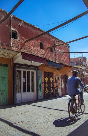 Marrakesh, Morocco - March 16, 2016 - man on bike in a Marrakesh backstreetのeditorial素材