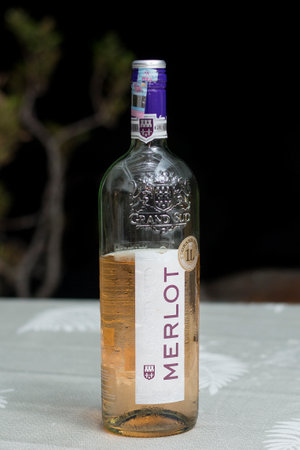 Close up of a bottle on a table.