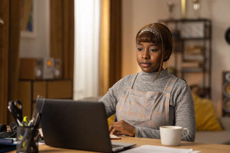 A dark-skinned girl prepares for an online meeting at her company. The woman wants to talk about the...