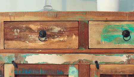 A part of an old wooden multi-colored cupboard as background
