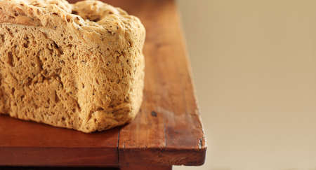 Homemade freshly baked multi grain organic healthy bread on an old wooden table with copy space