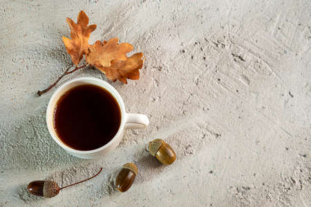 Cup of acorn coffee on a gray background. Substitute to atraditional coffee, a healthy homemade eco-friendly hot drink with a coffee flavor. Health and no caffeine concept. Flat lay, copy spaceの写真素材
