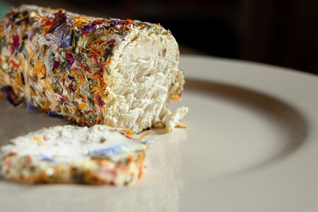 Original french goat cheese with honey and flowers on the light plate close-upの写真素材