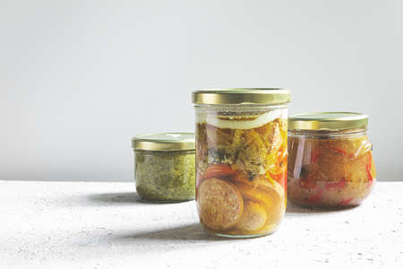 Homemade canned meat on a gray table, the jars with farm organic canned foodの写真素材