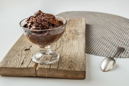 Chocolate mousse - traditional French dessert in a transparent bowl on a white tableの写真素材