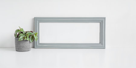 Gray mock up photo frame and home plant Tradescantia zebrina on a white background, bannerの写真素材