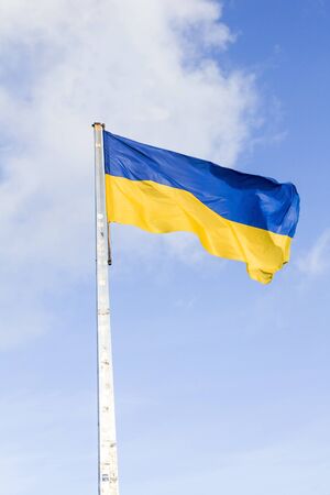 national flag of Ukraine on the cloudy sky backgroundの写真素材