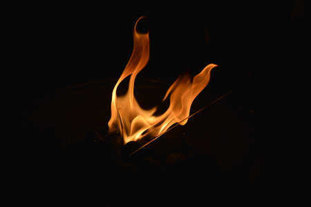 Bright flames in hearth on black background photoの写真素材