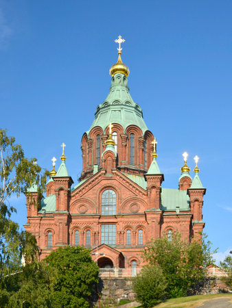 Helsinki, Finland. July,23, 2014. Uspenski Cathedral. Hilltop center of the Finnish Orthodox faith with an ornate exterior lavish interior decoration. Brick walls, green cupola and golden crosses on tops.の写真素材