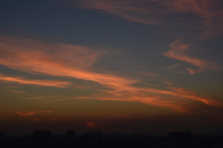Saint Petersburg Russia August 18 2016. Sunset golden sky with thin clouds, horizontal zigzag lines across heavenの写真素材