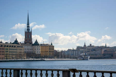 A sunny spring embankment in Stockholm, view over a pier at the city and old town STOCKHOLM, SWEDEN - March 17 2018.のeditorial素材