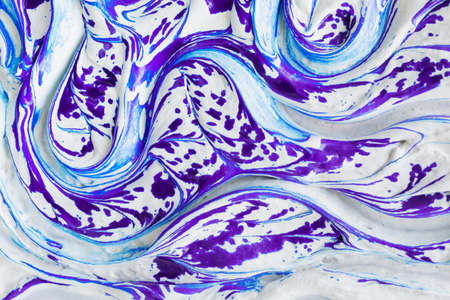 Fluid art artistic liquid marble texture background. White liquid soft cream surface with impressive splashes of violet ink and marble effect with long curved strips.の写真素材