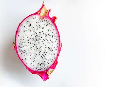 Pitahaya Dragon Fruit fresh half cutted with white pulp and balck seeds on a white background. Pitaya fruit top view photography with empty place for text or titleの写真素材