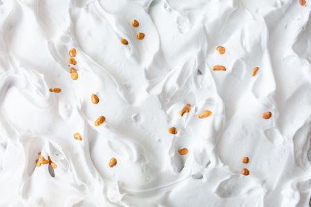 White creamy foam with golden drops of serum. cosmetic light background textureの写真素材