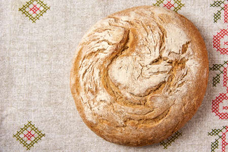 a loaf of bread on top of a linen tableclothの写真素材
