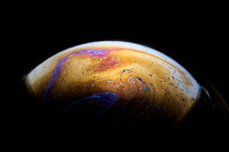 beautiful soap bubble up close on a black backgroundの写真素材
