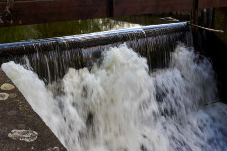 Overflow of water over the damの写真素材