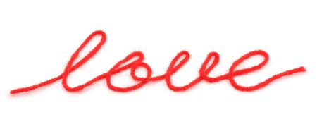bright red yarn in the shape of a word 'love'の写真素材