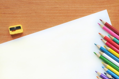 White blank with pencils on a wooden table