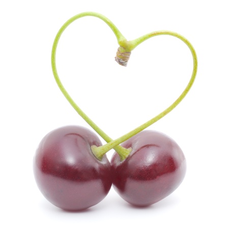 Heart-shaped pair of cherries isolated on white.
の写真素材