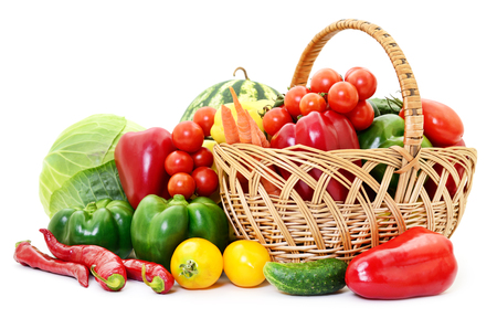 Variety of raw vegetables in wicker basket isolated on white.の写真素材