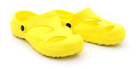 Closeup yellow rubber shoes on white background.