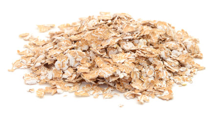 Rolled oat flakes heap or pile isolated on white backgroundの写真素材