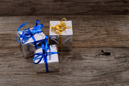 Gift boxes on wooden board background with space for text.の写真素材
