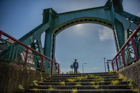 girl standing on an old bridge with stairsの写真素材