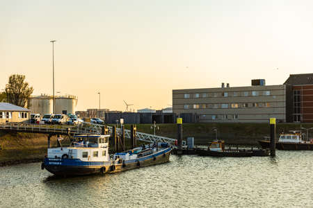 SPIJKENISSE, NETHERLANDS - April 17, 2020 Beautiful sunset in harbour, port, industrial landscape with shipsのeditorial素材