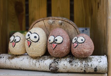 Four funny wooden birds sitting on the treeの写真素材